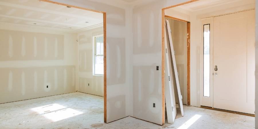 Skilled contractor repairing drywall seams and smoothing surfaces before painting in Milford, Delaware.
